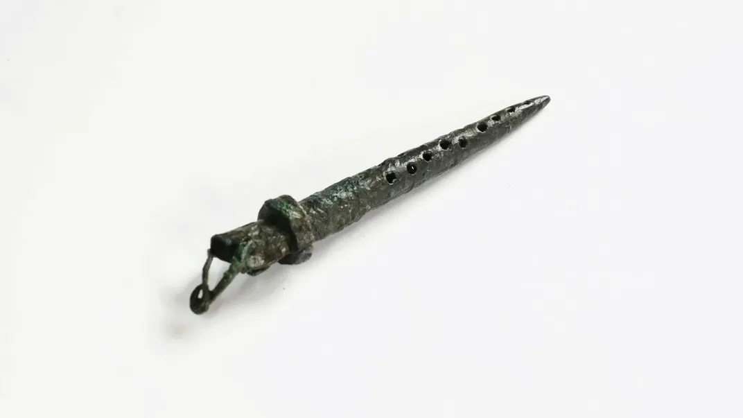 Bronze gadget against white backdrop