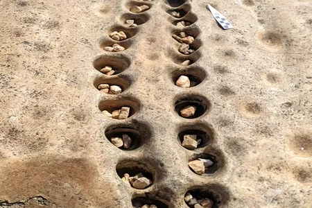 The rows of shallow pits were carved into a rock ledge in what is now the Lewa Wildlife Conservancy in central Kenya.