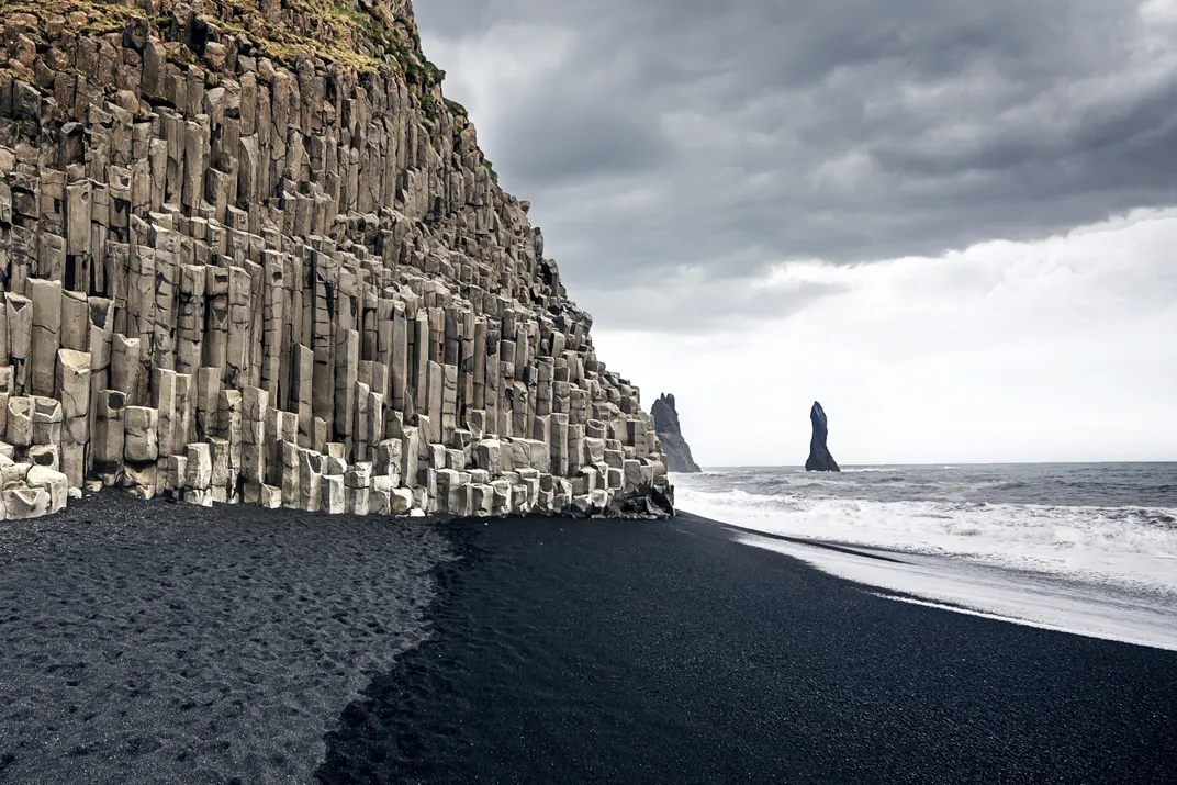 Basalt cliffs and black sand beach at Reynisfjara