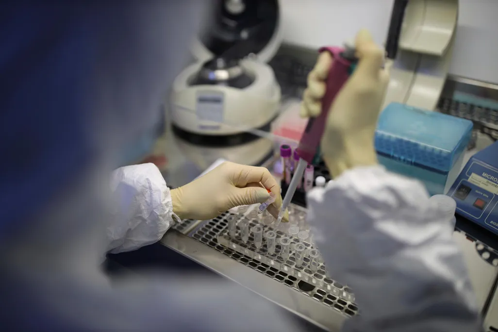 A medical staffer works with test systems for the diagnosis of coronavirus