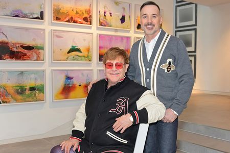 Elton John and David Furnish pictured at home in their art gallery in Windsor, England, in 2019