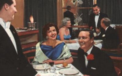Dining aboard the RMS Caronia, from a 1950s World Cruise brochure.