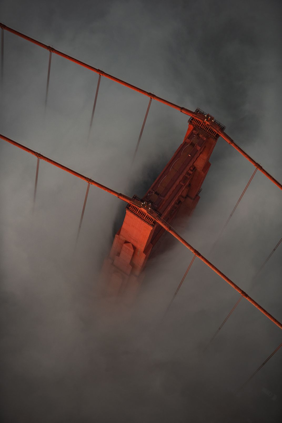 5 - San Francisco’s Golden Gate Bridge, opened in 1937, makes a magical appearance during a late afternoon summer fog.