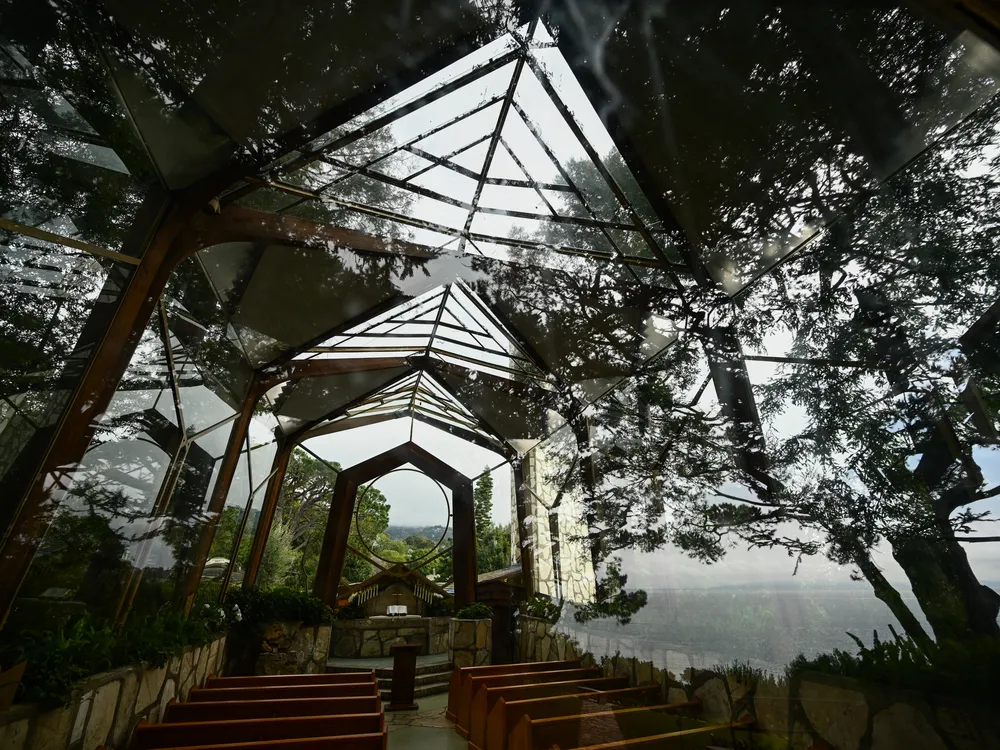 Glass-enclosed chapel with trees around it