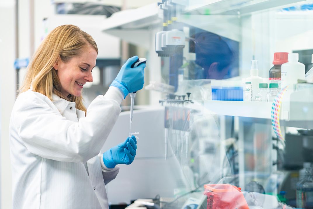 Scientist pipetting samples.