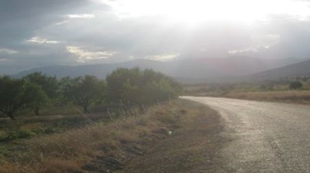 Sunlight bursts through a ceiling of rainclouds above the lonely west shore of Lake Burdur.