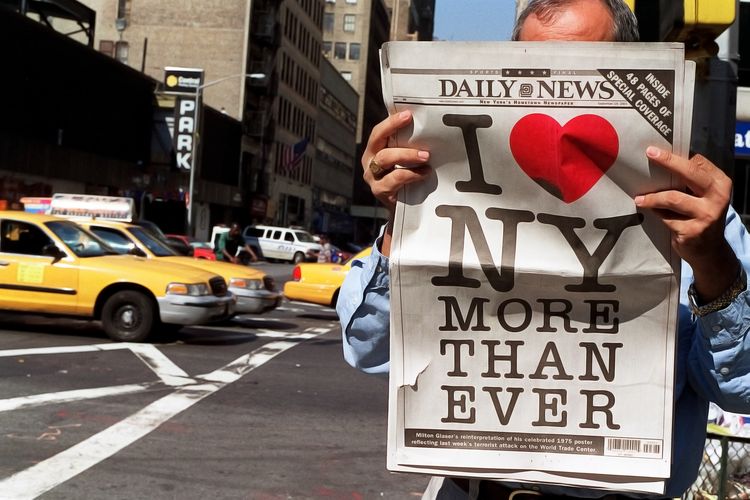 A man in New York City reads a copy of the September 19, 2001, issue of the&nbsp;Daily News, featuring Milton Glaser's updated "I &hearts; NY More Than Ever" logo.