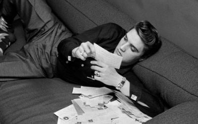 Elvis at 21: Presley reads fan mail on March 17, 1956