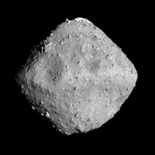 An image of the asteroid 162173 Ryugu  as it appears in space. The asteroid looks like a grey diamond shaped chunk.