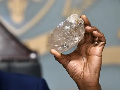 Botswana’s President Mokgweetsi Masisi holds up the newly discovered diamond, which weighs more than a pound.