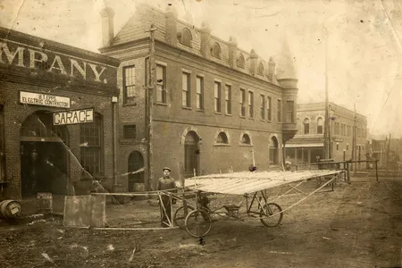 Ben Epps stands with the Epps-Huff II, long thought to be Georgia’s first airplane. It never flew. The handwriting suggests 1907 as the year aviation began in Georgia.