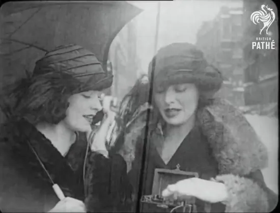 Two women from the 1922 film “Eve’s Wireless” operating a portable crystal radio