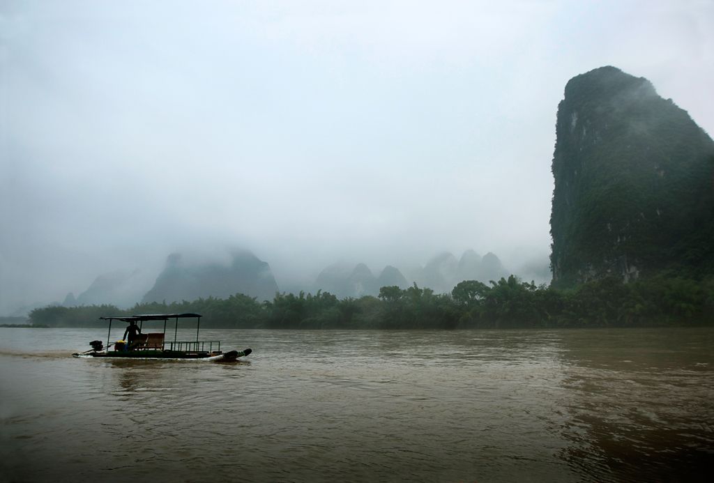 Local villager taking a boat up the Lijiang River in Guilin, China ...