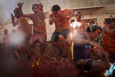 Revelers are splattered with tomatoes during the yearly La Tomatina festival in Bunol, Spain.