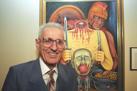 Jack Kevorkian stands in front of one of his paintings.