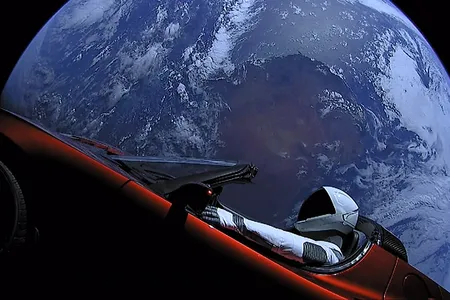 The Tesla Roadster and the mannequin &quot;Starman&quot; on the SpaceX Falcon Heavy upper stage, with Earth in background.