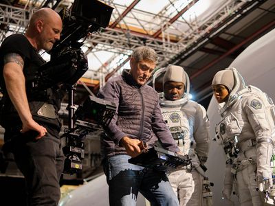 Director-star George Clooney confers with David Oyelowo and Tiffany Boone during the filming of a spacewalk sequence at London's Shepperton Studios.
