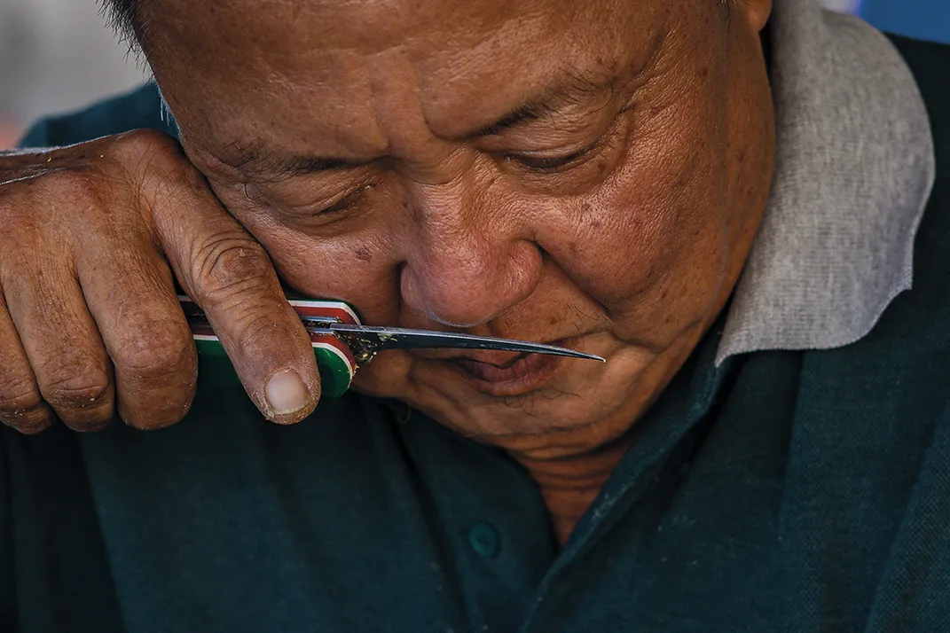 a man smells durian fruit