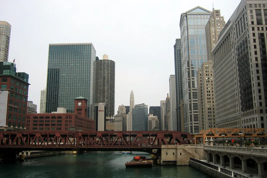 a bridge over the Chicago River with the city's tall downtown buildings in the background