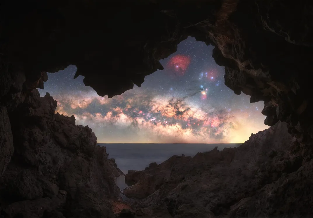 the milky way seen through a rock opening
