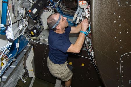 Don Pettit, working on repairs inside the International Space Station in 2008.