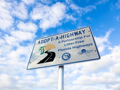 This Adopt-A-Highway sign is located on the Florida Keys Scenic Highway. The program, which began in Texas, is now used by states across the country.