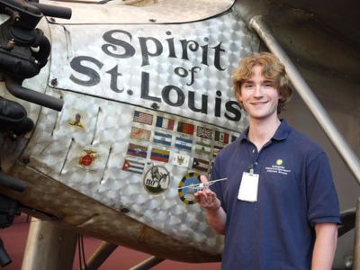 Museum specialist Chris Reddersen, holding a Spirit of St. Louis model that he and his dad built while Reddersen was in elementary school, got to work on the real thing as a volunteer at the National Air and Space Museum.