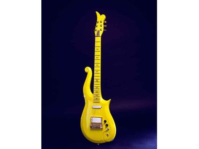 Prince designed and used this 1989 custom-made Yellow-cloud electric guitar, built by the Minneapolis firm Knut-Koupee. It features his personal symbol at the top and on the side of the fingerboard. 