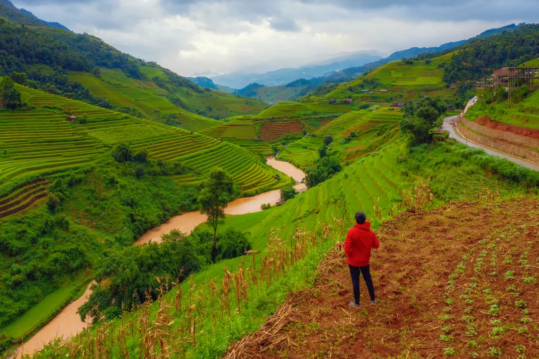 A hiker amid terraced paddies