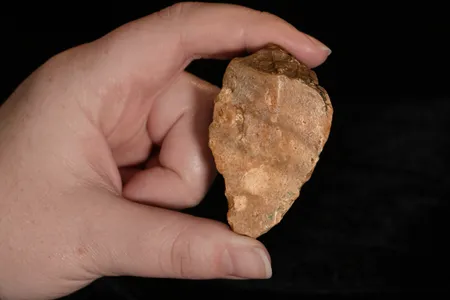 This stone tool found on the Indonesian island of Sulawesi, along with six others, suggest hominins were present on the island and making tools far earlier than thought.