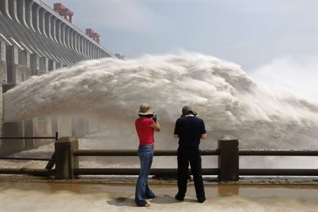 People take pictures of water gushing from the reservoir of China’s Three Gorges Dam, the largest hydropower station in the world.