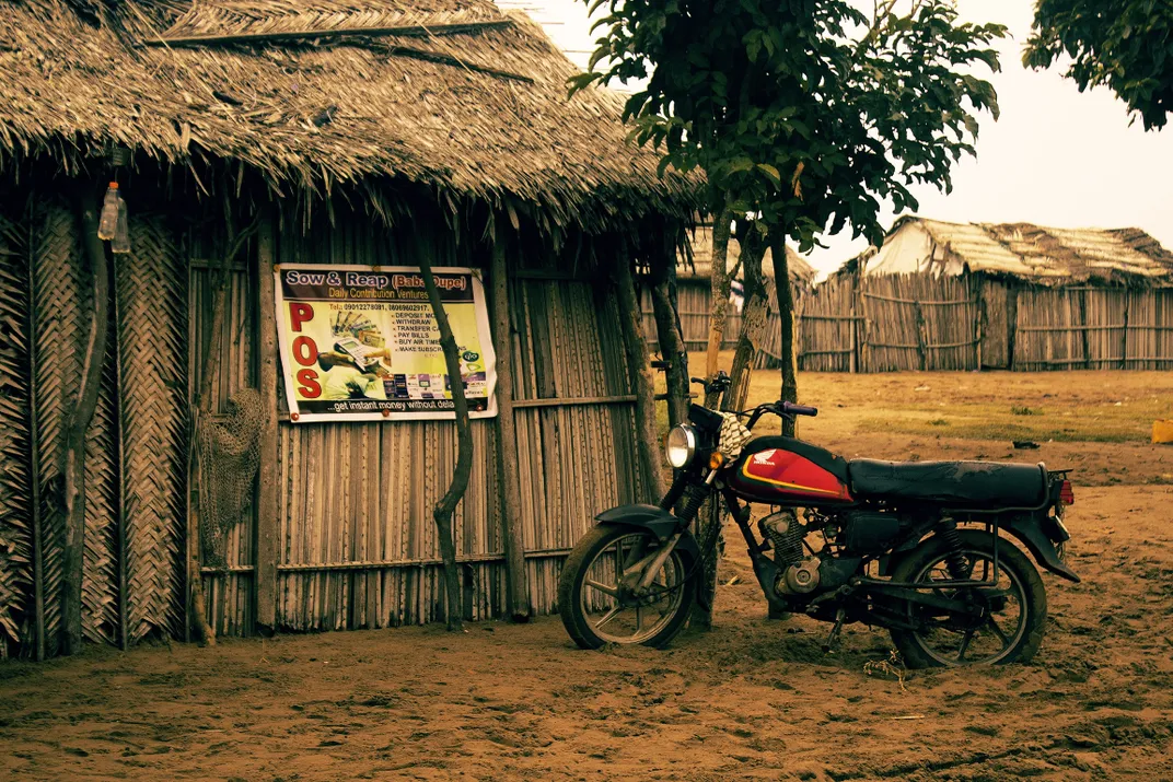 A motorcycle next to a hut
