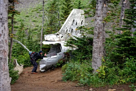 In 2014, backcountry hiker Jeff Lang photographs the tail of a downed Royal Canadian Air Force DC-3 Dakota on Mount Coulthard, Alberta, Canada. The airplane crashed in 1946 while en route from Comox, British Columbia to Greenwood, Nova Scotia, killing all seven on board.