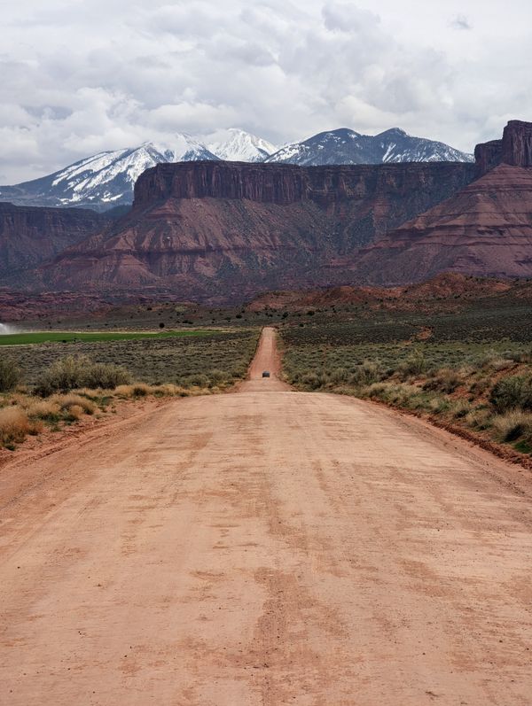 Dirt road to canyons and mountains thumbnail