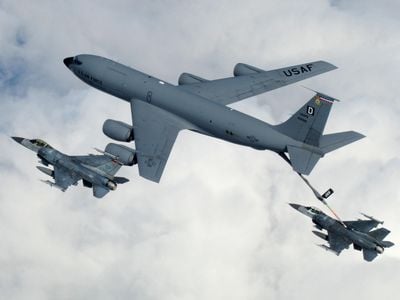 A KC-135 Stratotanker from Royal Air Force Mildenhall, England, refuels a pair of F-16 Fighting Falcons in flight.