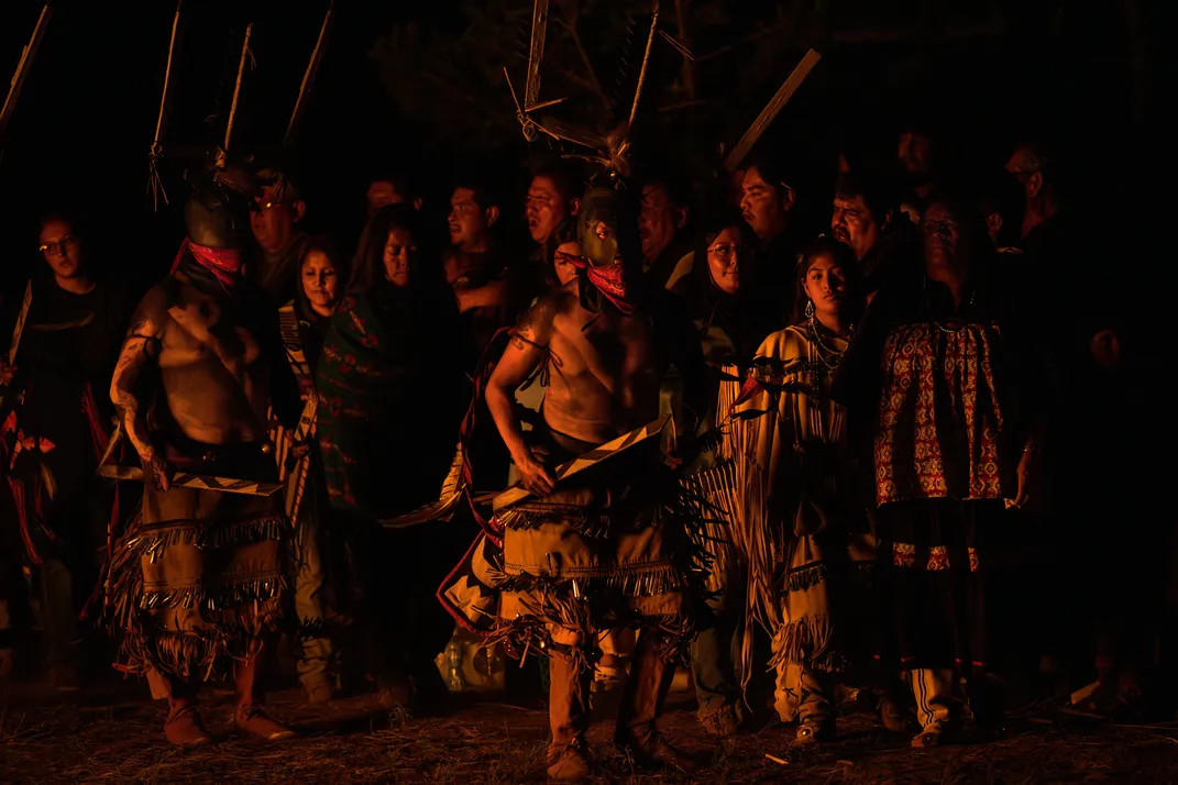 14 - Apache Crown Dancers bless a young woman during her coming-of-age ceremony while friends and family gather in support.