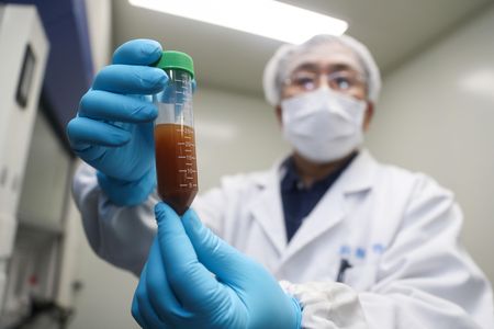 A researcher of Stermirna Therapeutics Co., Ltd. shows the experiment to develop an mRNA vaccine targeting the novel coronavirus in east China's Shanghai.