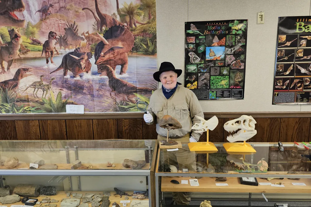 Boy in front of museum display cases