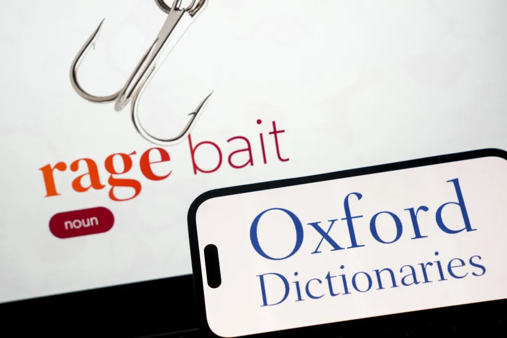 In this photo illustration, the logo of Oxford Dictionaries is displayed on a mobile phone screen next to the word of the year 2025 'rage bait' in Ankara, Turkiye on December 1, 2025.