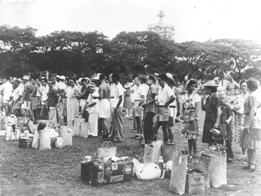 View of (mostly American) internees lining up on the grounds of the University of Santo Tomas in Manila, redesignated by the Japanese as Santo Tomas Internment Camp, in the early 1940s