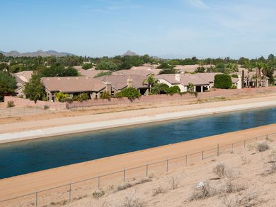 The CAP canal is pictured running past houses and businesses it feeds in Scottsdale, Ariz. The Central Arizona Project is a 336-mile, man-made river of canals that delivers water from the Colorado River basin uphill to service water needs in southern Arizona, including Tucson and Phoenix.