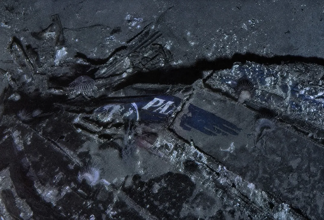 Wreckage of an airplane with the letters PAA visible