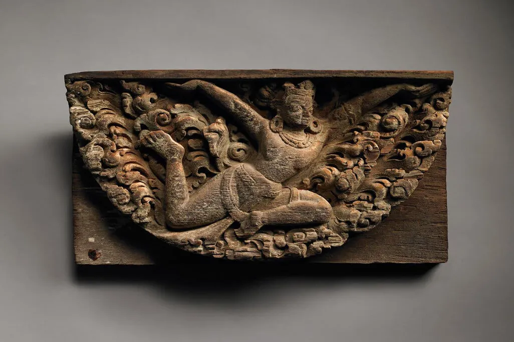 stone relief of woman flying with wings made of clouds