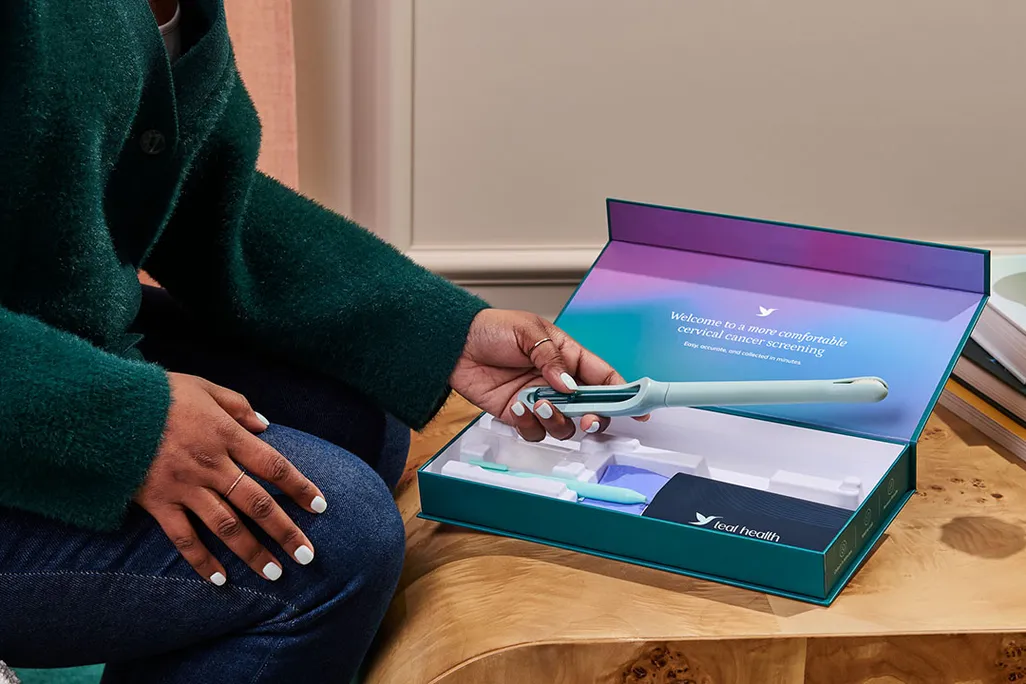 a woman holding an at-home test