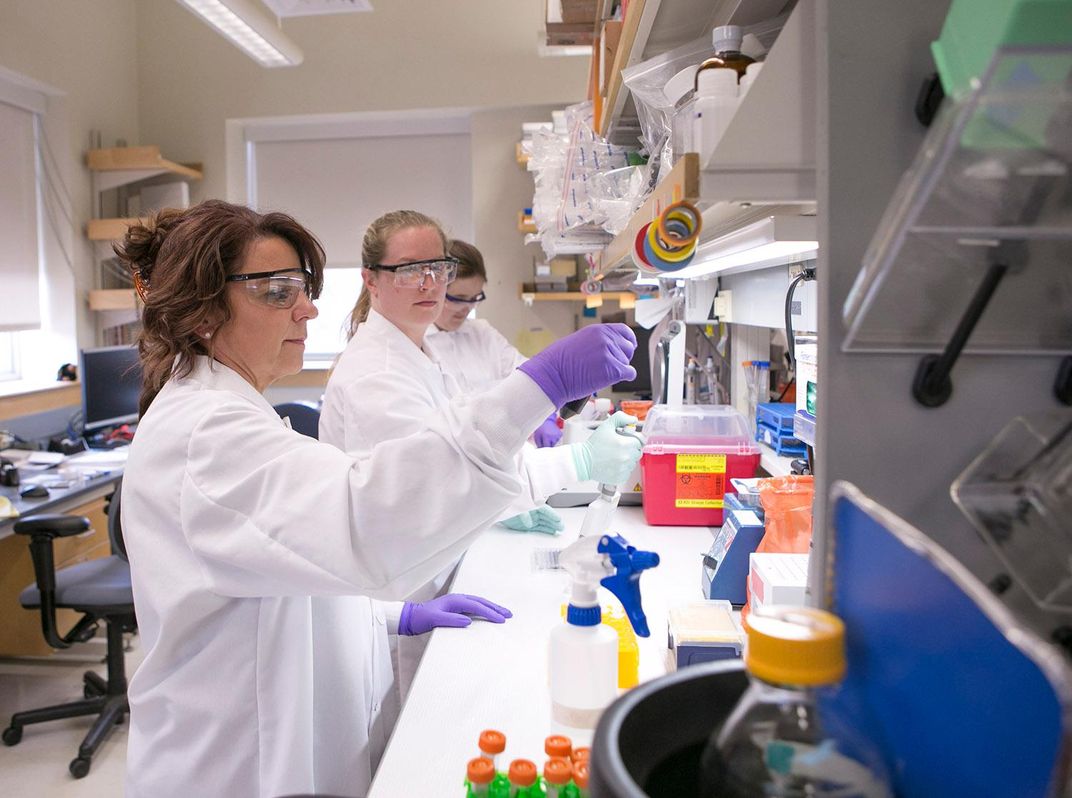 Cat Lutz (left) and colleagues at work in a lab at the Jackson Laboratory.