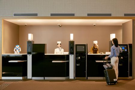Interacting with a velociraptor robot is just part of the Henn-na Hotel's efficient charm.