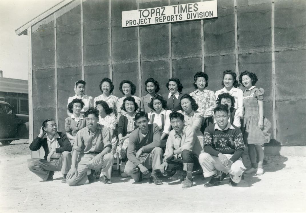 Mori (front row, far left) poses with other detainees in front of the Topaz War Relocation Center’s newspaper building.