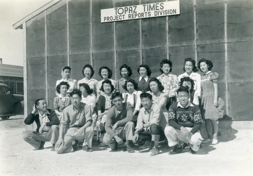 Mori (front row, far left) poses with other detainees in front of the Topaz War Relocation Center’s newspaper building.