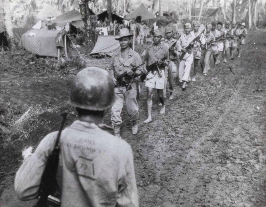 Filipino guerrillas under the command of Captain Jesus Olmedo meet Major General A.V. Arnold at the U.S. Army's Seveneth Division headquarters in 1944.