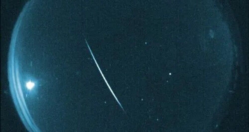 a meteor streaks across the sky